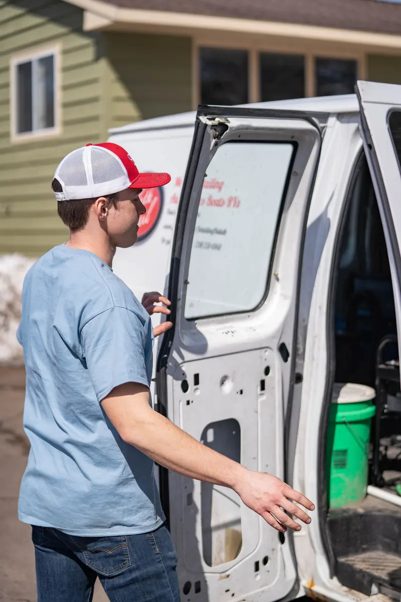 A technician working the door of a van